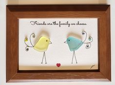 there are two birds in the frame with words on it that say friends are the family we choose