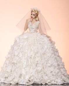 a barbie doll wearing a white wedding dress and veil with flowers on it's skirt