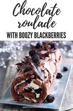 chocolate roulade with blackberries on a blue plate and text overlay reads chocolate roulade with boozy blackberrys