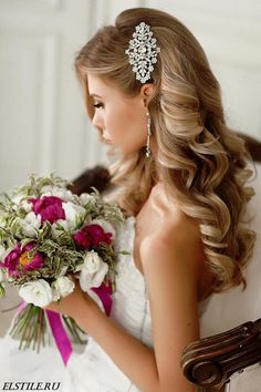 a woman in a wedding dress holding a bouquet of flowers