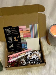 an open box filled with assorted items on top of a white blanket