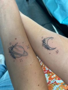 two tattoos on the legs of people with stars and planets in them, one has a saturn tattoo on it's arm