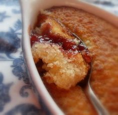 a close up of food in a bowl with a spoon