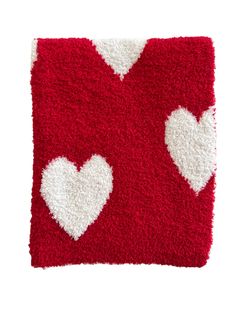 a red and white rug with hearts on the front, one in the shape of a heart