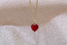 Gold filled red ruby heart stud charm pendant necklace. with matching earring option. Dainty minimalistic red heart tiny charm necklace High quality 18k gold plated  With adjustable chain - Length option of 14'' to 16'' ,or 16'' to 18''  chain. Dainty minimalistic pendant charm. Great as a gift ,or for yourself for that special occasion! Any questions feel free to ask! Thanks for supporting a small family run business! Comes packaged in a beautiful box ready to gift! Red Heart Gold Necklace, Ruby Pendant Jewelry For Valentine's Day, Red Ruby Jewelry Gift For Her, Heart-shaped Ruby Jewelry For Valentine's Day, Heart-shaped Ruby Birthstone Jewelry, Ruby Heart Charm Jewelry, Ruby Heart Pendant Jewelry For Valentine's Day, Ruby Heart Pendant For Valentine's Day, Valentine's Day Ruby Heart Pendant Jewelry