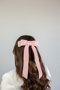 Stunning velvet ribbon bow with double loops at the top. Beautiful long ribbon tails.The Judy Bow is secured to a 3" barrette and available in two lengths. Approximate bow measurements: LONG: 6.75" wide by 11" long SHORT: 6.75" wide by 7" long *Please note these bows are handcrafted and therefore vary slightly in size. Measurements are approximate.**Any props seen in photo are not available for sale. The Judy bow is sold individually regardless if it is shown in photos with multiple bows. Pink Bow In Hair, Pink Bow Hair, Velvet Hair Bow, Pink Hair Bow, Long Bow, Pink Hair Bows, Bow Hairstyle, Satin Ribbon Bow, Ribbon Hairstyle