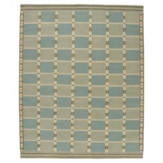 a blue and beige rug with squares on it