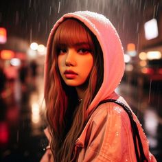 a young woman with red hair wearing a pink hoodie and holding an umbrella in the rain