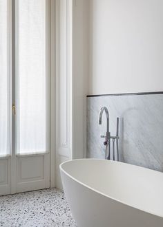 a white bath tub sitting next to a window