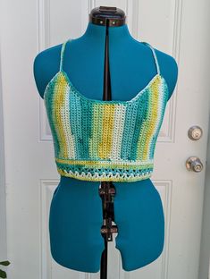 Extra large handmade crochet top with lace-up back in shades of green & yellow. 100% cotton. Sizing (Bust Measurement): XS = 28-30" S = 32-34" M = 36-38" L = 40-42" XL = 44-46" XXL = 48-50" For best care, hand wash or machine wash in delicates bag on a gentle cycle and lay flat to dry. Made from Sneak A Peek pattern (with modifications) by Kelsie at PassioKnit Goods, passioknitgoods.com. Green Summer Crochet Top With Crochet Trim, Green Crochet Trim Summer Top, Fitted Crochet Cotton Tank Top, Bohemian Green Crochet Crop Top, Green Bohemian Tops With Crochet Trim, Green Crochet Lace Crop Top For Summer, Green Bohemian Crochet Lace Top, Green Handmade Cotton Crochet Top, Handmade Green Cotton Crochet Top