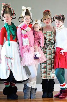 three women and two children are dressed up in costumes for the holiday season, standing next to each other