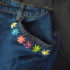 a pair of jeans with colorful flowers on them