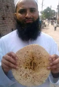 a man with a beard holding up a piece of bread