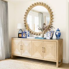 a mirror and some vases on top of a dresser