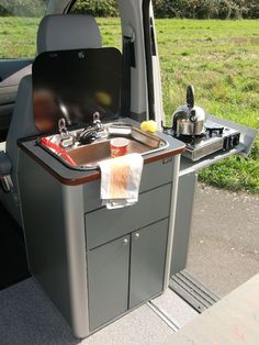 an outdoor kitchen in the back of a van