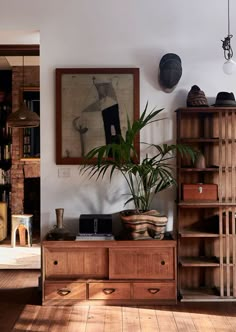 a living room filled with furniture and a painting on the wall next to a book shelf