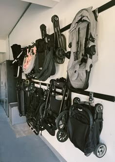 there are many baby strollers hanging on the wall