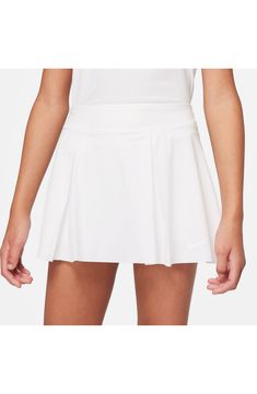 This breathable, kid-sized golf skirt will keep them comfortable on the green with a pleat-flared silhouette, stretchy inner shorts and helpful hidden pockets. 86% polyester, 14% spandex Machine wash, line dry Imported Nordstrom x Nike: A curated lifestyle destination where fashion is the ultimate sport Fitted Golf Skort With Built-in Shorts, Solid Color Pleated Tennis Skort, Solid Pleated Tennis Skort, Solid Pleated Skort For Tennis, Pleated Tennis Skirt With Short Inseam, Solid Color Pleated Tennis Dress, Solid Pleated Tennis Dress, Pleated Tennis Bottoms In Solid Color, White Fitted Skort For Golf