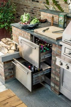 an outdoor kitchen with stainless steel appliances