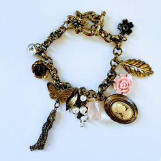 Antique Victorian Brass Charm Bracelet W/ Cameo Locket & Many Unique Pieces Rare Charm Bracelet Featuring But Not Limited To: Cameo Locket Crystal Enamel Tassel Quartz Pearls Porcelain Beautiful Toggle Closure! Cameo Locket, Victorian Brass, Locket Bracelet, Jewelry Antique, Brass Charms, Antique Victorian, Antique Gold, Locket, Unique Pieces