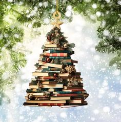 a christmas tree made out of books hanging from a branch