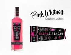 a bottle of pink wine sitting on top of a white table next to a banner