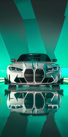 the bmw concept car is shown in front of a green wall and reflective flooring