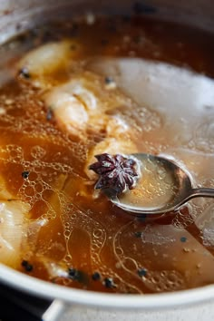 a spoon in a pot filled with soup