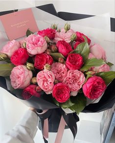 a bouquet of pink flowers sitting on top of a table