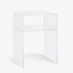 an acrylic side table with a clear plastic shelf on the top and bottom