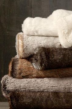 a pile of fur and blankets on top of each other