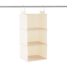 a white hanging shelf with three shelves on it