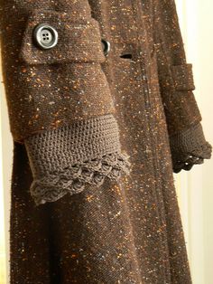 a coat is shown with buttons on it