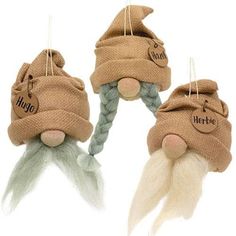 three gnomes with hats and beards hanging from strings, one has long white hair