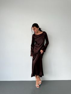 This stunning chocolate maxi dress is crafted from luxurious, dense Italian silk satin, offering a smooth, elegant drape. The dress features long sleeves and a sophisticated neckline, perfect for formal events, evening wear, or any special occasion where you want to make a statement. With its minimalist design and impeccable craftsmanship, this gown will become a timeless addition to your wardrobe. Its versatile style makes it easy to dress up with heels or keep it casual with flats. - Material: Dense Italian silk satin - Color: Chocolate - Long sleeves for a classic, elegant look - Perfect for formal events, weddings, or evening outings - Made with care to ensure a comfortable fit and luxurious feel Available sizes:XS, S, M, L, XL, XXL. Measurements: Size XS: Bust up to 86 cm (33.9 in), H Long Sleeve Satin Dress, Satin Long Sleeve, Elegant Drapes, Black Maxi, Brown Silk, Satin Color, Silk Satin, Satin Dresses, Evening Wear