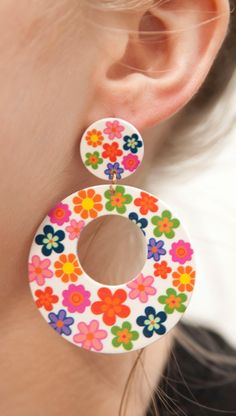 Embrace the vibrant spirit of the 1960s with these 60s Chunky Flower Hoop Earrings. Inspired by the bold and colorful fashion of the era, these earrings feature chunky flower-filled hoops that exude a retro charm. Crafted from lightweight acrylic, these earrings offer comfort without compromising on style. The posts are made of stainless steel, coated in 18k gold for an added touch of elegance, and are nickel-free to ensure a comfortable wearing experience. Product Details: Design: The 60s Chunk Vintage Summer Hoop Earrings, Retro Flower-shaped Jewelry For Summer, Vintage Multicolor Earrings For Spring, Multicolor Vintage Earrings For Spring, Retro Multicolor Flower Jewelry, Pink Retro Earrings For Spring, Retro Flower Earrings For Spring, Retro Spring Flower Earrings, Fun Multicolor Flower Earrings