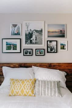 a bed with pillows and pictures on the wall above it is featured in an instagram