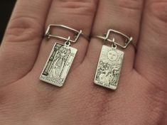 "Copy and paste into your browser, get 15% off ➔ https://bit.ly/VD15OFF Why not get a statement dangle ring for your jewelry collection? Offering all 22 tarot cards from The Major Arcana, the choice is yours with this tarot card ring. DETAILS: -One Ring -Sterling Silver -18mm x 10mm tarot card -Stainless Steel Adjustable US Size 6-11 Ring -1mm Thick Stainless Steel You will receive one stainless steel adjustable tarot card ring. **Every item is handmade, this means that each will be unique and may not look EXACTLY like the picture, but it will look very similar ➡ORDER PROBLEMS If there are any problems with your order please contact me, my goal is for you to be happy with your products and I will do what I can to help! ➡BULK ORDERS I gladly make bulk orders! For every bulk order of 15+, th Adjustable Wire Bracelet, Mystic Jewelry, Card Ring, Dangle Ring, Jewelry Goth, The Major Arcana, Friendship Ring, Mystical Jewelry, Wire Bracelets