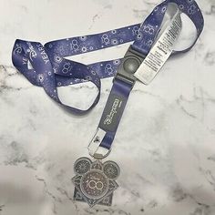 a lanyard with a heart shaped medal attached to it on a marble counter top