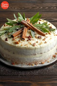 a white cake topped with cinnamons and sprigs