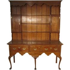 an old fashioned wooden cabinet with drawers