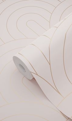 a roll of white paper with gold lines on it