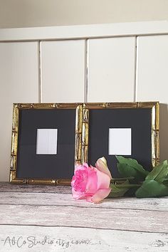 two framed pictures with pink flowers on a table