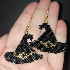 Elevate Your Halloween Style With These Exquisite Handmade Black And Gold Beaded Earrings, Designed In The Shape Of A Witch Hat. Crafted From High-Quality Japanese Glass Miyuki Delica Beads, These Earrings Measure Approximately 1.25 Inches In Length And 1.5 Inches In Width, Making Them A Perfect Statement Piece For Any Festive Occasion. Their Unique Design And Meticulous Craftsmanship Ensure That You Will Stand Out While Celebrating The Season. Black Beaded Dangle Earrings For Halloween, Black Dangle Beaded Earrings For Halloween, Black Beaded Earrings With Ear Wire For Festival, Black Beaded Earrings For Festival, Adjustable Black Jewelry With Bead Caps, Handmade Black Halloween Earrings, Adjustable Beaded Earrings For Halloween, Adjustable Black Jewelry For Costume, Adjustable Black Costume Jewelry