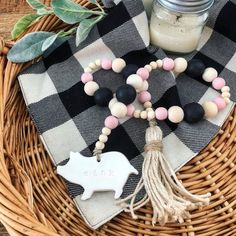 a black and white checkered table cloth with a wooden bead necklace on it