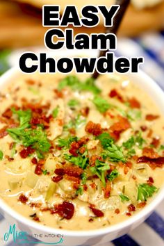 this easy clam chowder is loaded with bacon, cheese and parsley in a white bowl