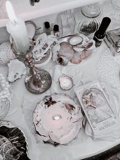 the table is covered with dishes and candles