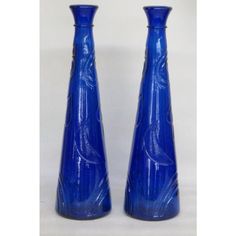 two blue vases sitting next to each other