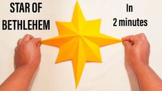 two hands holding an origami star with the words, star of bethlem in 2 minutes