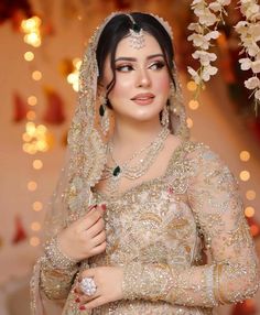 a woman in a bridal gown posing for the camera